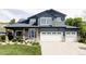 Charming two-story home with a well-manicured lawn and a two-car garage at 6123 Dunraven Rd, Golden, CO 80403
