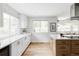 Well-lit kitchen with white cabinets, stainless appliances, and bright tile backsplash at 6123 Dunraven Rd, Golden, CO 80403