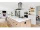 Modern kitchen showcasing a large island, stainless steel appliances, and white cabinetry at 6123 Dunraven Rd, Golden, CO 80403