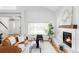 Bright living room featuring hardwood floors, large windows, and a modern fireplace at 6123 Dunraven Rd, Golden, CO 80403