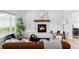 Cozy living room featuring hardwood floors, a stone fireplace, and stylish furnishings at 6123 Dunraven Rd, Golden, CO 80403