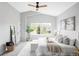 Main bedroom featuring a large window, neutral decor, vaulted ceilings and an overhead fan at 6123 Dunraven Rd, Golden, CO 80403