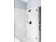 Modern bathroom shower with white tile and matte black shower head and hardware at 6123 Dunraven Rd, Golden, CO 80403