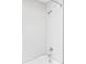 White subway tile shower complete with chrome fixtures, shower head, and faucet at 6123 Dunraven Rd, Golden, CO 80403