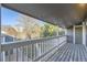 View of the neighborhood from the covered balcony with wood-plank flooring and white railing at 18043 E Ohio Ave # 202, Aurora, CO 80017
