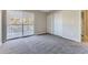Bedroom featuring neutral carpet and a sliding glass door that opens to a deck at 18043 E Ohio Ave # 202, Aurora, CO 80017