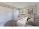 Bedroom with a large bed, closet, and a window at 18043 E Ohio Ave # 202, Aurora, CO 80017