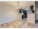 Open dining area features tiled floor, modern light fixture, and access to the kitchen at 18043 E Ohio Ave # 202, Aurora, CO 80017