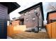 View of the exterior of the house from the backyard and a tall wooden fence at 2751 Curtis St, Denver, CO 80205