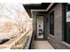 Balcony view into the home, showcasing the reading nook, exposed brick, and street view at 2751 Curtis St, Denver, CO 80205