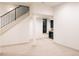 Large basement space with neutral carpet, kitchenette, black window and staircase at 2751 Curtis St, Denver, CO 80205