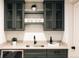 Finished basement wet bar with wine fridge, storage, and a stainless steel sink at 2751 Curtis St, Denver, CO 80205