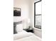 Bright bedroom featuring a bedside table with lamp, modern decor, and a view from the window at 2751 Curtis St, Denver, CO 80205