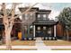 Beautifully renovated two-story home with brick facade, covered porch, and manicured front yard at 2751 Curtis St, Denver, CO 80205