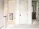 Hallway with open doors to the home's bathroom, rooms, and an iron stair railing at 2751 Curtis St, Denver, CO 80205