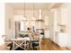 Bright, modern kitchen featuring stainless steel appliances, pendant lighting, and a glass dining table at 2751 Curtis St, Denver, CO 80205