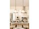 Stylish kitchen island with seating, pendant lights, stainless steel appliances, and plenty of counter space at 2751 Curtis St, Denver, CO 80205