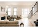 Open-concept living room featuring a fireplace, hardwood floors, and a staircase at 2751 Curtis St, Denver, CO 80205