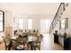 Open-concept living room and dining area with hardwood floors, large windows, and a modern staircase at 2751 Curtis St, Denver, CO 80205