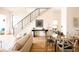 Open living and dining area with hardwood floors, modern staircase, and bright natural light at 2751 Curtis St, Denver, CO 80205