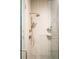 Modern tile shower featuring a rainfall shower head and glass door at 2751 Curtis St, Denver, CO 80205