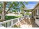 Beautiful backyard with a covered patio, stone walkway, and mature trees at 8951 Greenwich St, Highlands Ranch, CO 80130