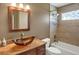 Bathroom featuring a glass bowl sink, granite countertop, and tiled shower at 8951 Greenwich St, Highlands Ranch, CO 80130