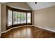 A bedroom featuring vaulted ceilings, hardwood floors, and a window with plantation shutters at 8951 Greenwich St, Highlands Ranch, CO 80130