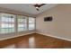 An empty bedroom with three windows and hardwood floors, ready for personalization and comfort at 8951 Greenwich St, Highlands Ranch, CO 80130