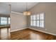 Open dining room showcasing hardwood floors, plantation shutters, and modern chandelier at 8951 Greenwich St, Highlands Ranch, CO 80130