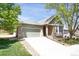 Single-story home with a brick and siding exterior, a two-car garage, and a well-manicured lawn at 8951 Greenwich St, Highlands Ranch, CO 80130