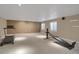 Spacious home gym area with carpeted flooring and bright natural light from large windows at 8951 Greenwich St, Highlands Ranch, CO 80130