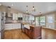 Well-appointed kitchen featuring a center island, stainless steel appliances, and white cabinetry at 8951 Greenwich St, Highlands Ranch, CO 80130