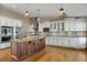 Bright kitchen featuring stainless steel appliances, a spacious island, and custom cabinetry at 8951 Greenwich St, Highlands Ranch, CO 80130
