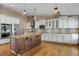 Gourmet kitchen with stainless steel appliances, custom cabinetry, and a large island at 8951 Greenwich St, Highlands Ranch, CO 80130