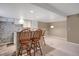 Kitchenette featuring white cabinets, granite countertops, and seating area with wood chairs at 8951 Greenwich St, Highlands Ranch, CO 80130