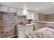 Kitchenette featuring white cabinets, granite counters, tile backsplash, and stainless steel sink at 8951 Greenwich St, Highlands Ranch, CO 80130