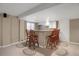 Kitchenette featuring white cabinetry, granite counters, tile backsplash, and bar seating at 8951 Greenwich St, Highlands Ranch, CO 80130
