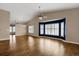 Bright living room featuring hardwood floors, a ceiling fan, and a large bay window at 8951 Greenwich St, Highlands Ranch, CO 80130