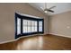 Spacious living room boasting hardwood floors, vaulted ceilings, and a bay window with white shutters at 8951 Greenwich St, Highlands Ranch, CO 80130