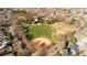 Beautiful aerial view showcasing the nearby park with mature trees and a baseball field at 2397 E Iliff Ave, Denver, CO 80210