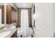 The bathroom includes a shower and bath, vanity, mosaic backsplash, and storage cabinet at 2397 E Iliff Ave, Denver, CO 80210