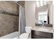 This cozy bathroom has tiled walls, decorative accents, and a shower with a tub at 2397 E Iliff Ave, Denver, CO 80210
