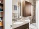 The bathroom includes a shower and bath, vanity, mosaic backsplash, and storage cabinet at 2397 E Iliff Ave, Denver, CO 80210