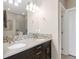 Elegant bathroom with double vanity, neutral walls, decorative mosaic tiles, and a glass enclosed shower at 2397 E Iliff Ave, Denver, CO 80210
