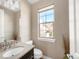 Powder room with vanity and window offering natural light at 2397 E Iliff Ave, Denver, CO 80210