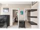 Bright bedroom featuring neutral walls, floating shelves, and artful decor leading to an ensuite bath at 2397 E Iliff Ave, Denver, CO 80210