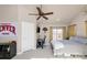 Cozy bedroom features a ceiling fan, desk, and natural light from the window at 2397 E Iliff Ave, Denver, CO 80210