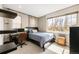 Bedroom with large window, desk, and bed at 2397 E Iliff Ave, Denver, CO 80210