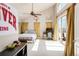Expansive bedroom with tall ceiling, fan, desk, and lots of natural light at 2397 E Iliff Ave, Denver, CO 80210